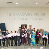Another view of the friends and family cut the dedication ribbon.